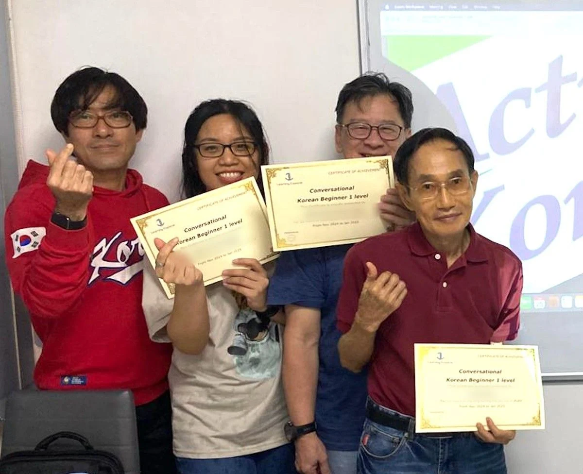 Students and their teacher with their Korean Beginner 1 certificates