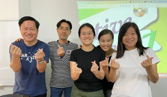 Students celebrating at the end of a Korean course